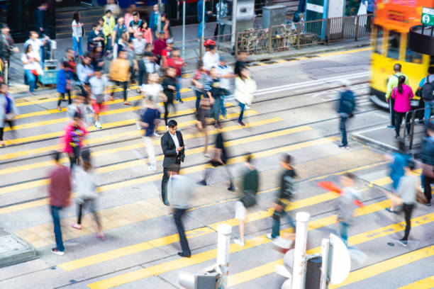 istock Mature Chinese Office Worker Standing Out From the Crowd 1254569905