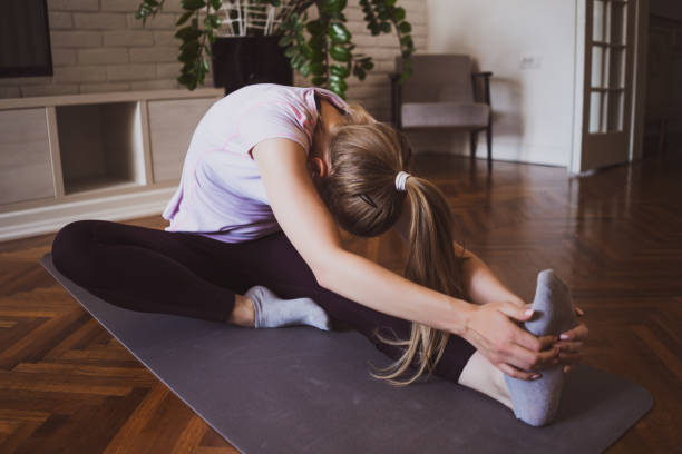 istock Woman exercising at home 1254569970