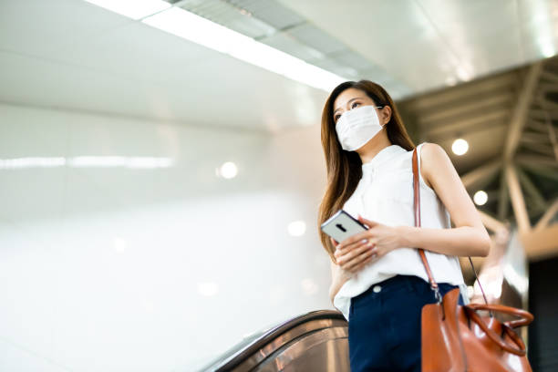istock woman use phone with mask 1254573370