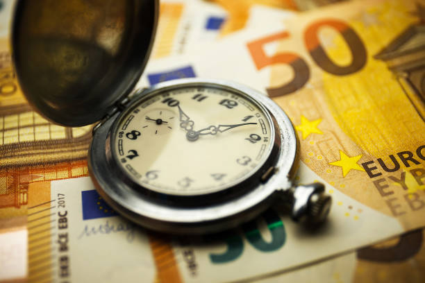 istock Time is money concept with euros banknotes. 1254574662