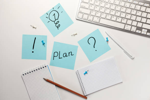 istock Pictogram marks on sticky notes on office desk on white background top view. 1254574796