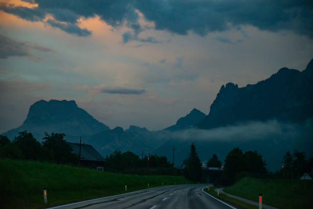 istock panoramic view of wet road in alpine mountains 1254574828