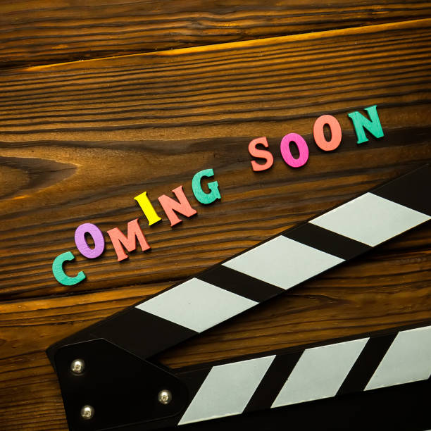 istock Coming soon text on the wooden background 1254574940