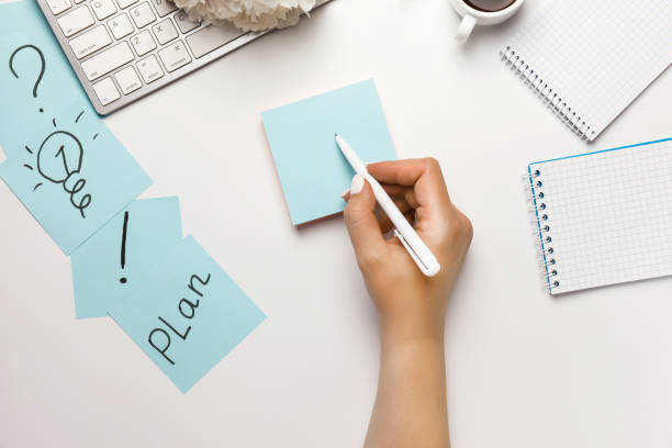istock Pictogram marks on sticky notes on office desk on white background top view. 1254575722