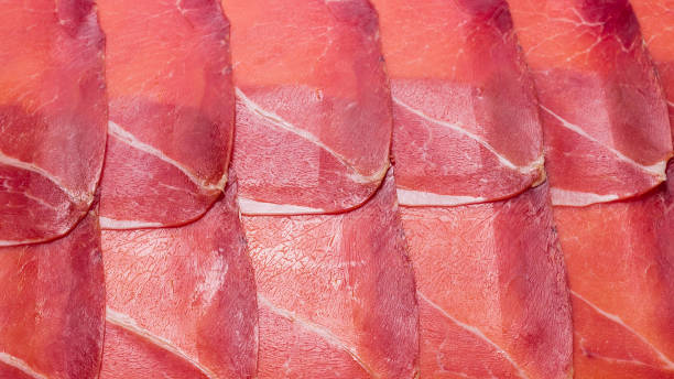 istock Tasty meat background, thinly sliced jamon. 1254575808