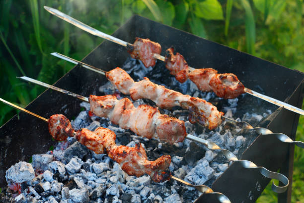 istock Cooking barbecue skewers. Marinated kebab is grilled on charcoal. 1254576135