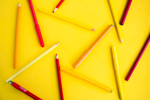 istock Color pencils on bright yellow background, education concept 1254576354