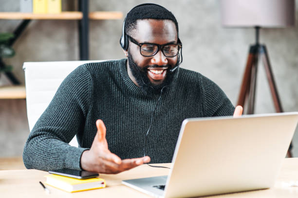 istock African-American guy with headset using laptop 1254577029