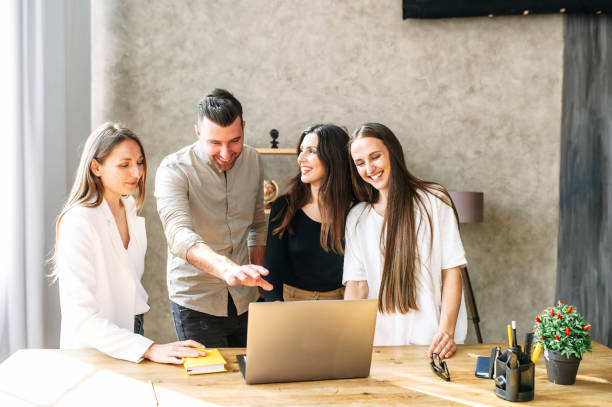 istock Young team works on laptop at the office desk 1254577097