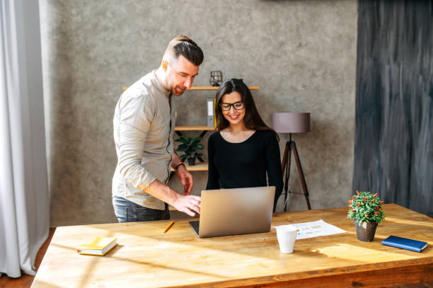 istock Pair of friendly colleagues work in office 1254577102