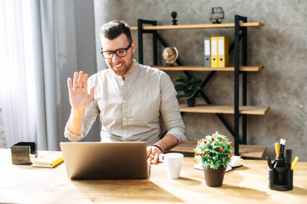 istock Attractive guy uses laptop for a video call 1254577103