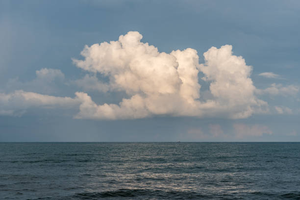 istock Calm Sea, Black Sea and white clouds on a Blue Sky Background 1254577761