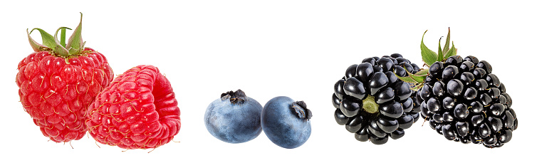 Fresh raspberries, blueberries and blackberries isolated on white background