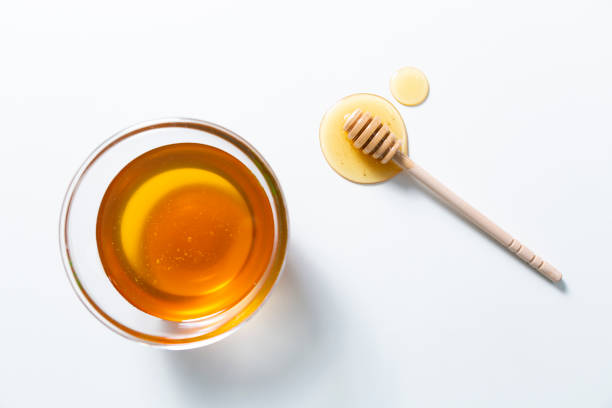 istock Fresh honey bee in bowl on white background. top view 1254581099