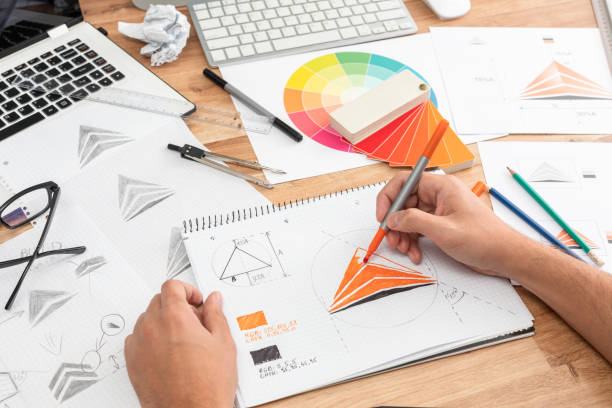 istock Graphic designer drawing sketches logo design. 1254582894