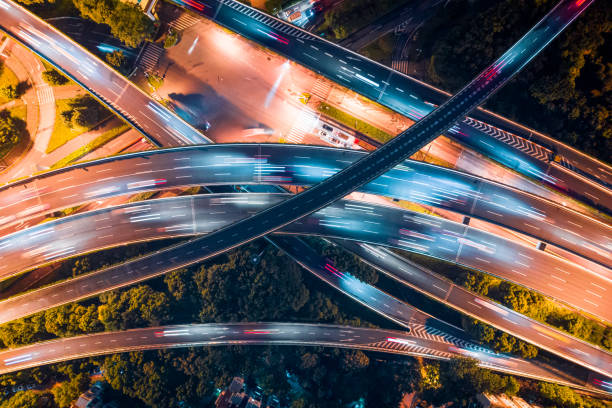 vertical aerial view of city overpass by drone at night stock photo