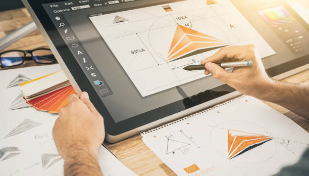 istock Graphic designer drawing sketches logo design. 1254584317