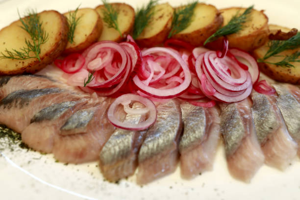 istock Sliced herring with baked potatoes and marinated onions 1254584409