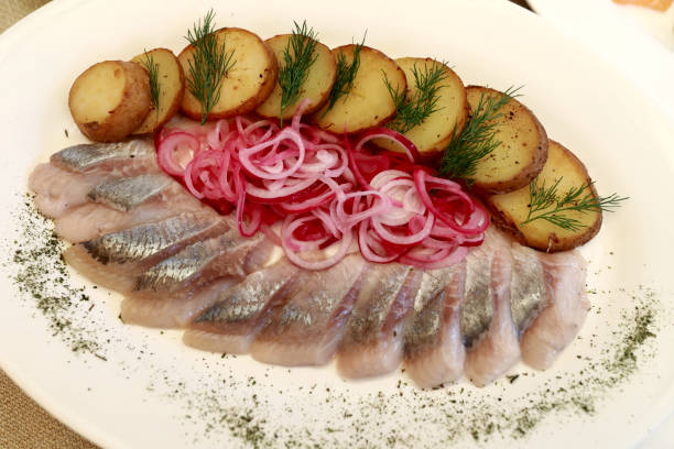 istock Sliced herring with potatoes and marinated onions 1254584414