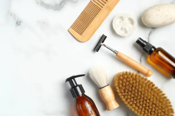 Photo of Shaving and bath accessories for man on marble background. Flat lay, overhead. Zero waste, sustainable lifestyle concept.