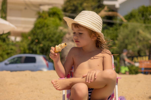 istock The girl is sitting on the beach 1254585512