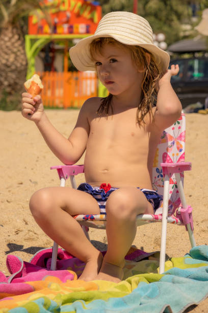 istock The girl is sitting on the beach 1254585676