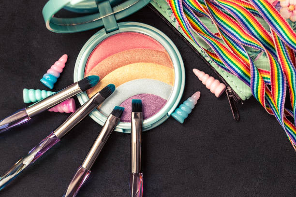 istock Rainbow glitter eye shadow palette, makeup brushes, shell decorations, rainbow ribbon, top view image 1254586124