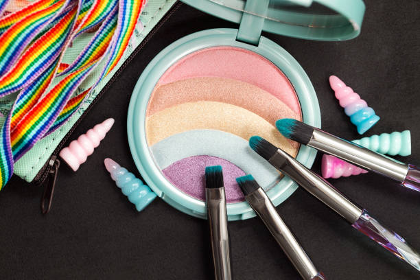istock Rainbow glitter eye shadow palette, makeup brushes, shell decorations, rainbow ribbon, top view image 1254586133
