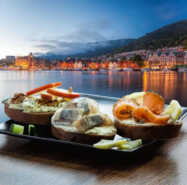 Typical Scandinavian sandwiches against Bryggen street with boats in Bergen, UNESCO World Heritage Site, Norway