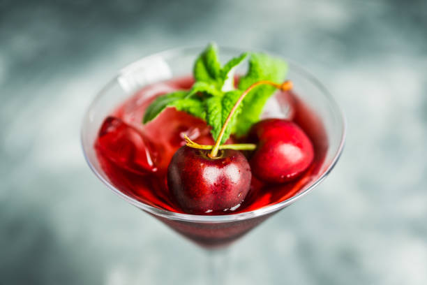 istock Cherry cocktail in martini glass with berries and mint leaves 1254586586