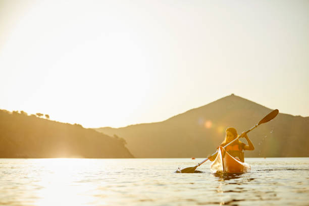 istock Woman Kayaking On River In Summer During Sunset Post Covid-19 1254587349