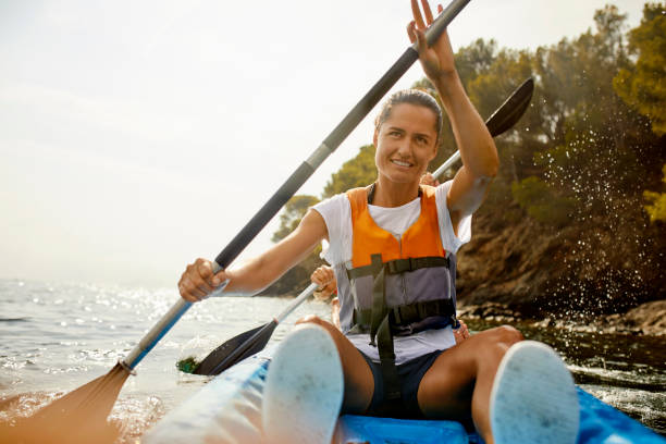 istock Smiling Woman Kayaking On River During Summer 1254587511