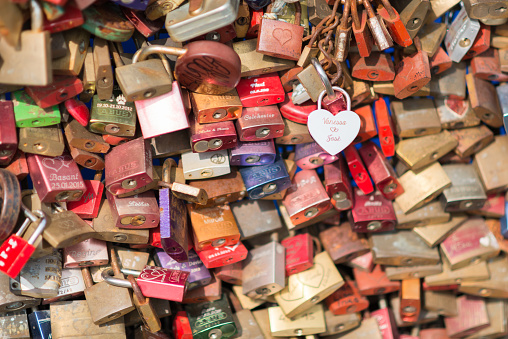 Cologne, Germany - September 22, 2016:  This bridge - the Hohenzollern bridge in Cologne Germany is full of love padlocks. A lot of young couples have made this padlocks over the years, so its a sightseeing of Cologne to walk over this bridge and read the messages.