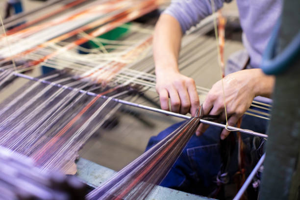 istock Man Working on Weaving Machine for Weave Handmade Fabric 1254588052