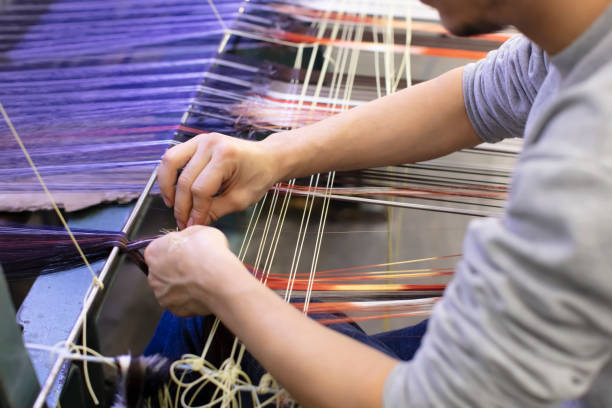 istock Man Working on Weaving Machine for Weave Handmade Fabric 1254588907