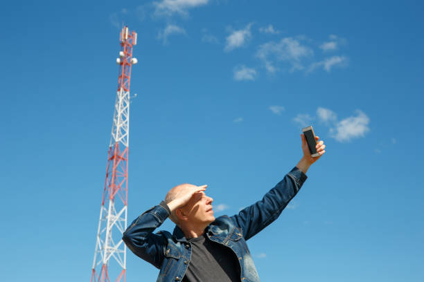 istock Man is trying to catch a mobile network signal 1254590701