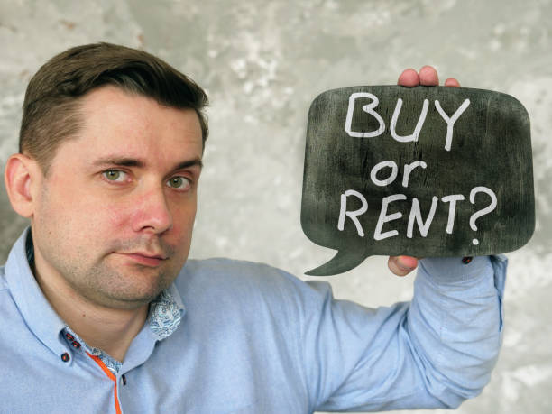 istock A man holds a sign saying Buy or rent. 1254590898