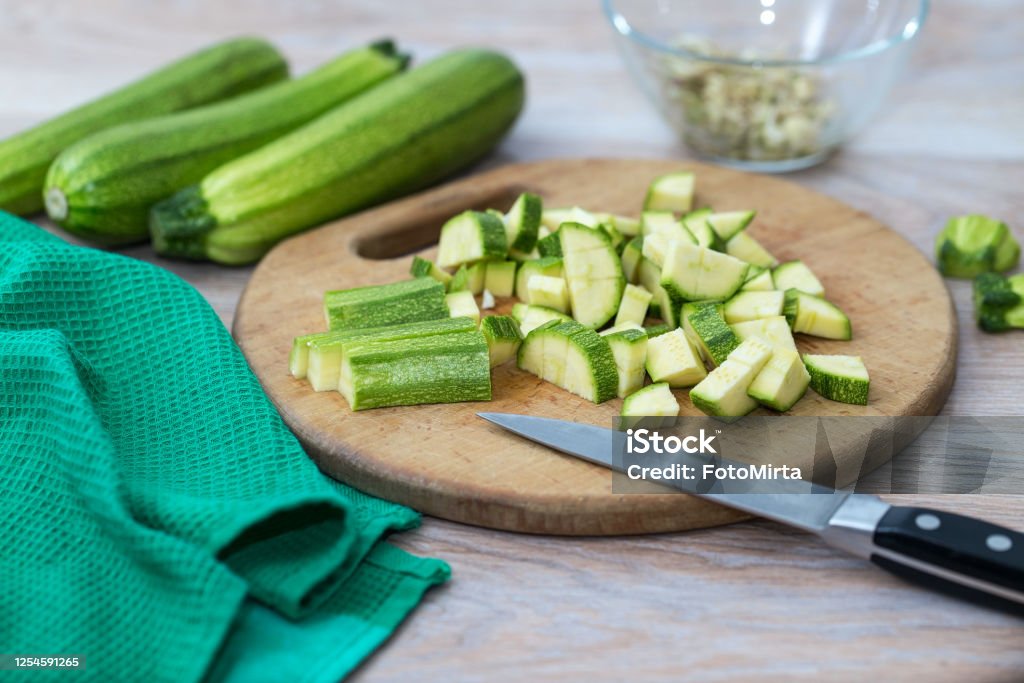 Green zucchini, sliced on a cutting Board, fresh vegetables for cooking at home Green zucchini, sliced on a cutting Board, fresh vegetables Zucchini Stock Photo