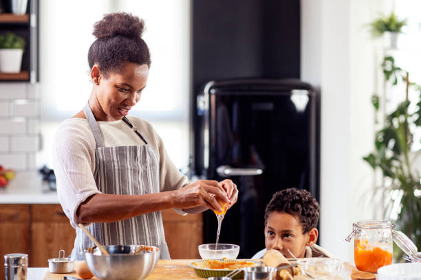 istock Woman prepare pie in the kitchen and learn his son cooking 1254593101