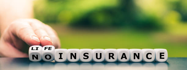 hand turns dice and changes the expression "no insurance" to "life insurance". - clause imagens e fotografias de stock