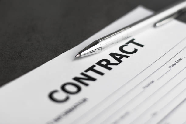 istock Business Contract and pen close up on grey background 1254599321