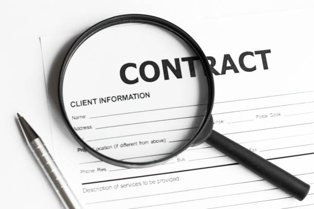 istock Magnifying glass over papers with pen 1254599323