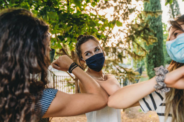 istock Three friends greeting each other with an elbow bump 1254600201