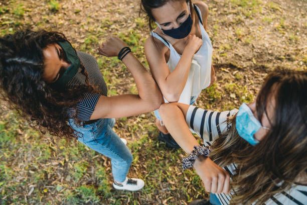 istock Three friends greeting each other with an elbow bump 1254600202