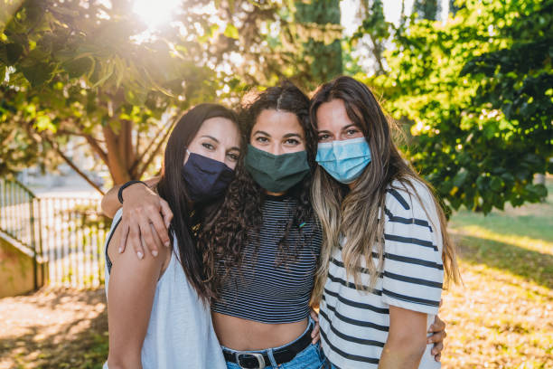 istock Portrait of three friends wearing protective facemasks 1254600282