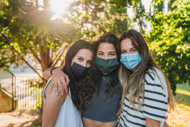 istock Portrait of three friends wearing protective facemasks 1254600283