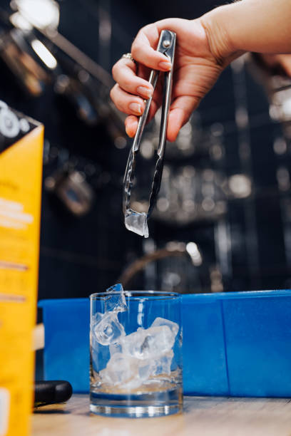 istock Crushed ice with bar forceps in a glass for a cocktail 1254600618