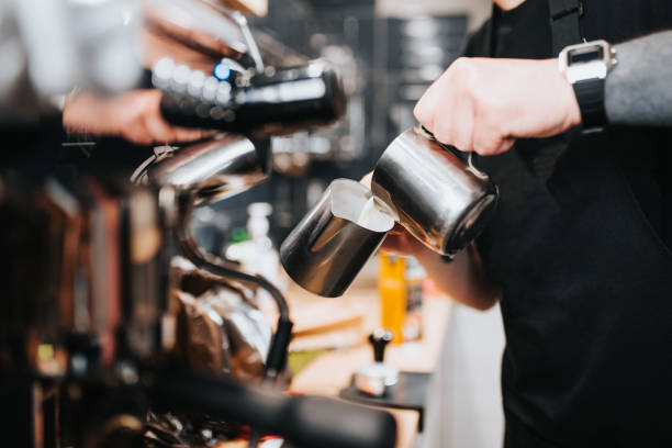 istock Barista professional pours milk from a pitcher - adding milk 1254600717