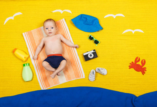 istock Funny kid is lying on a sandy beach. Beach and sea. Summer vacation 1254600984