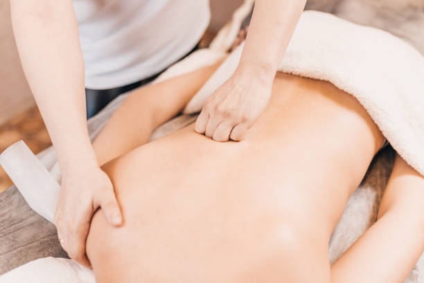 istock Hands of a professional masseur at work - a deep effect on the muscles and tissues 1254601198